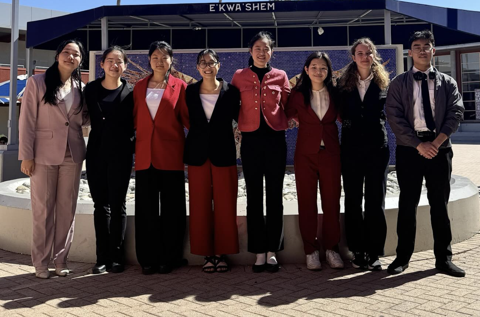 Troy Speech & Debate students competing at a tournament podium